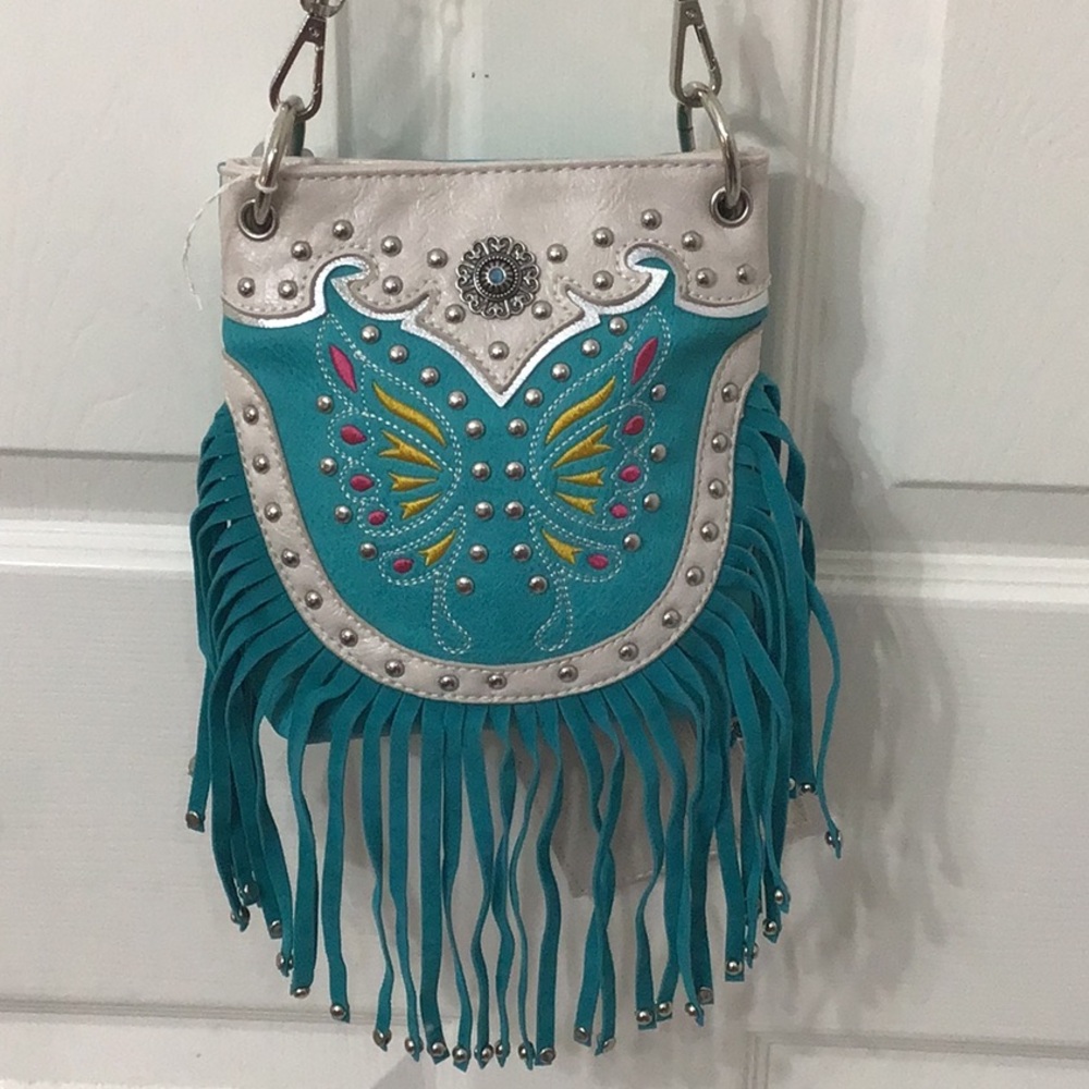 Turquoise cross body bag w/ fringe & card holder. 28” strap as hanging. Can tie.